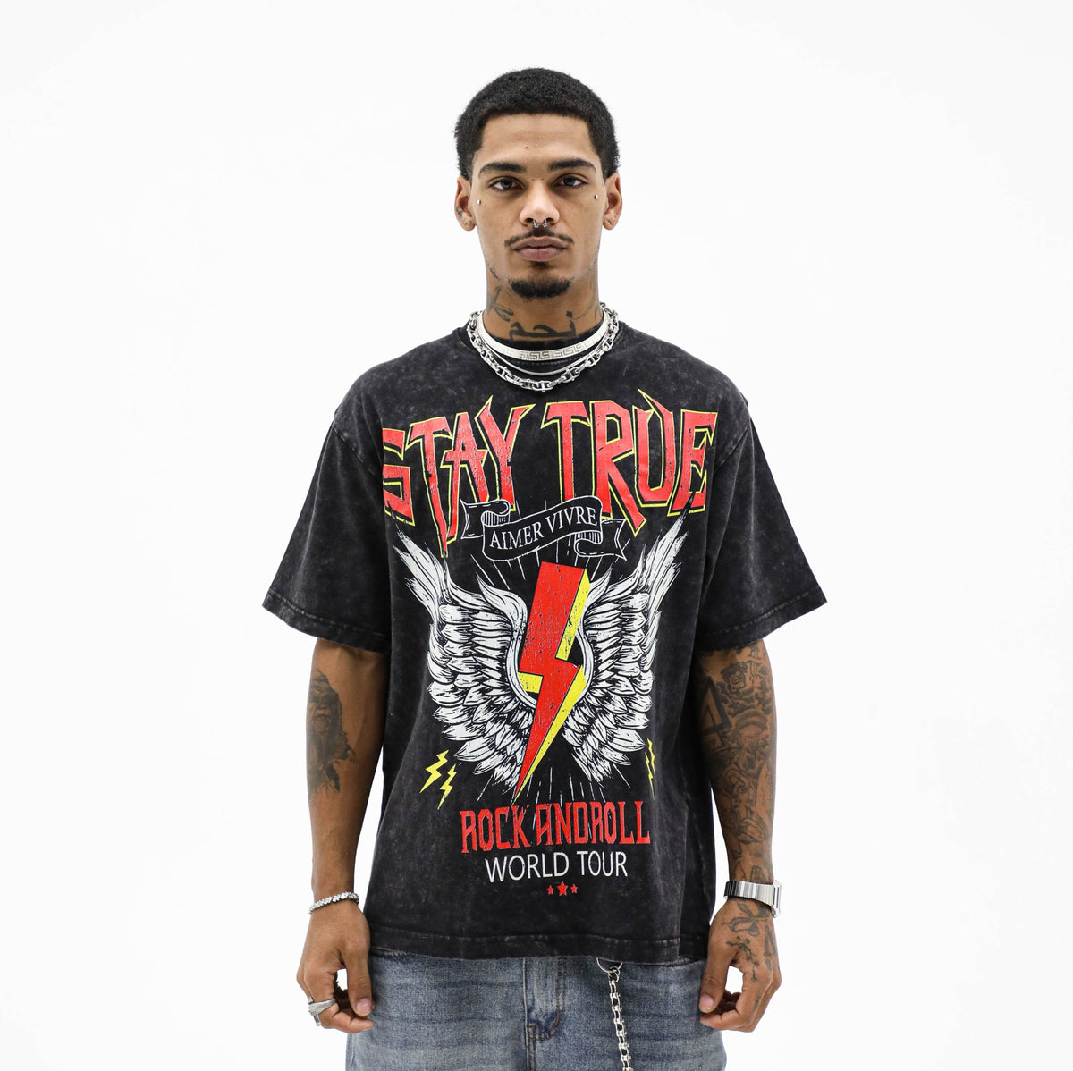 Model wearing the mineral wash Stay True Tee with a red winged lightning bolt graphic